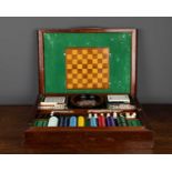 A cased games compendium with silvered top, comprising an integral chessboard, pieces, dominos,