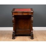 A Victorian oak davenport, the lift top with red and gilt tooled leather surface over fitted