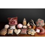 A collection of antique and later pin cushions to include beaded examples, and a sweetheart