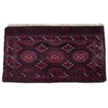 Bokhara burgundy ground rug with elephants foot panels, 155cm x 86cmOld repairs and wear.