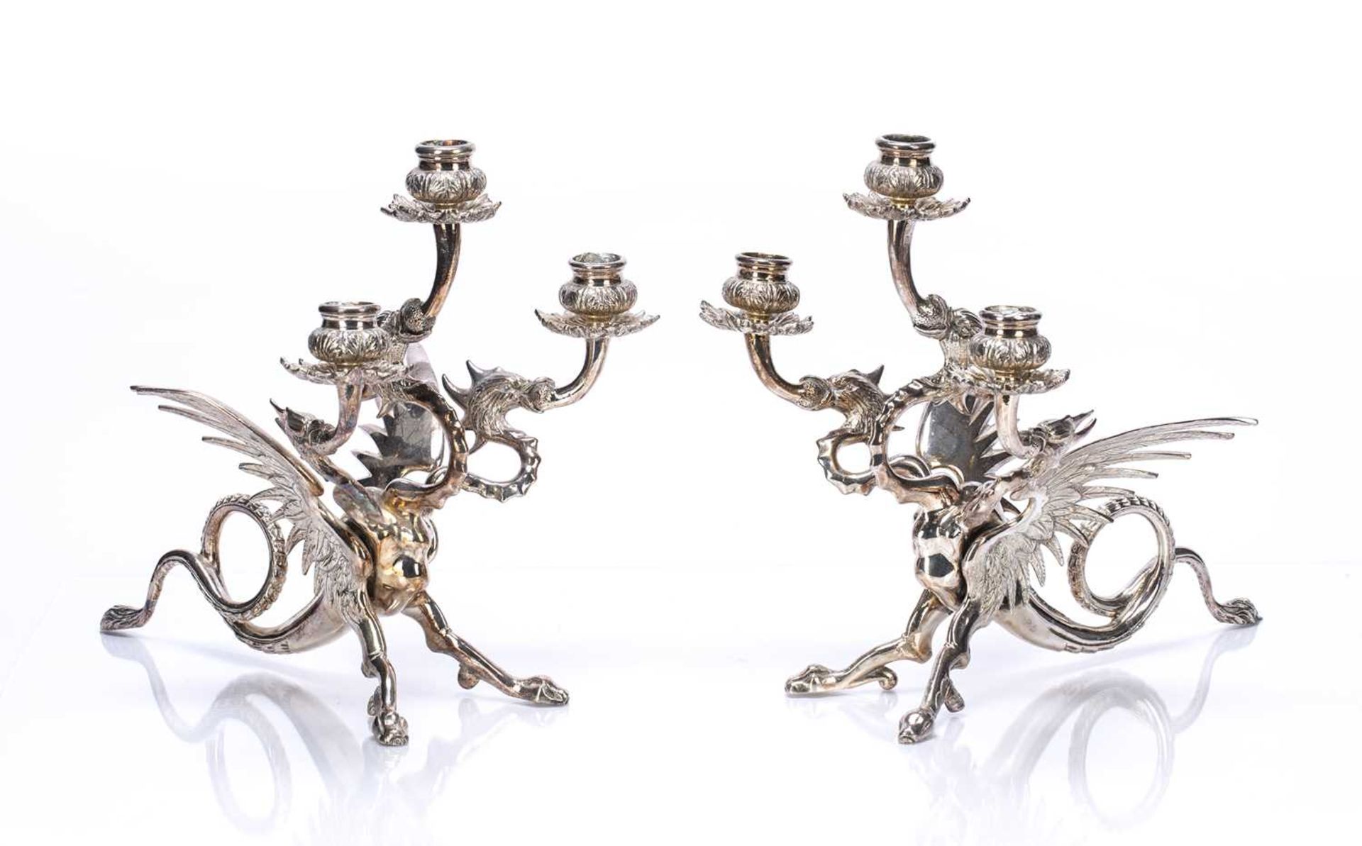 Pair of silver plated three branch candleabra in the form of a phoenix, unmarked, 29cm high