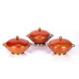 Three Furstenberg porcelain tureens and covers coral or terracotta coloured with gilt decoration and