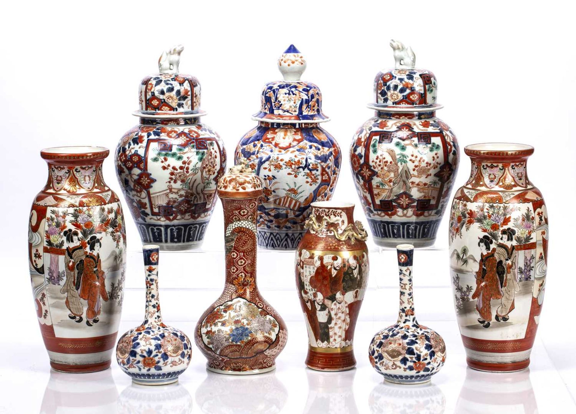 Group of nine Imari and Kutani vases Japanese, comprising of a pair of lidded vases surmounted