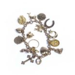 9ct gold charm bracelet and assorted 9ct gold and unmarked precious yellow metal charms, 18.5cm