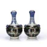 Pair of famille noire tulip neck vases Chinese, each painted with courtiers in a famille verte