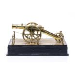 Brass scale model of a cannon 20th century, unsigned, on a black painted plinth, 32cm x 14.5cm x