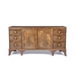 Mahogany sideboard Early 19th Century, two cupboard doors flanked by three drawers, with brass