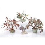 Four hardstone trees Chinese, 20th Century, with variously coloured petals, two set-in celadon style