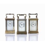 Three brass cased carriage clocks early/mid 20th Century, one made in France, with white enamel