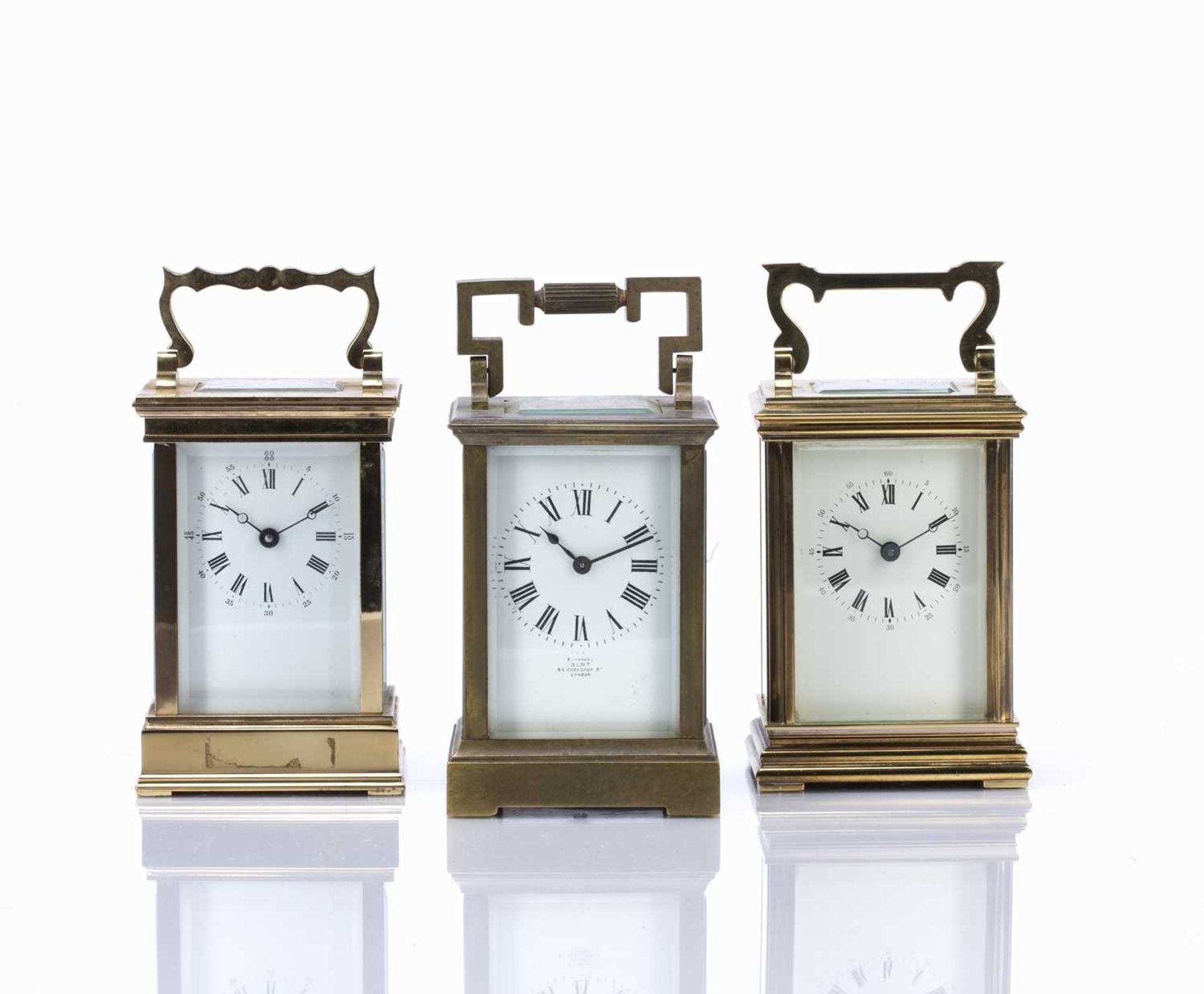 Three brass cased carriage clocks early/mid 20th Century, one made in France, with white enamel
