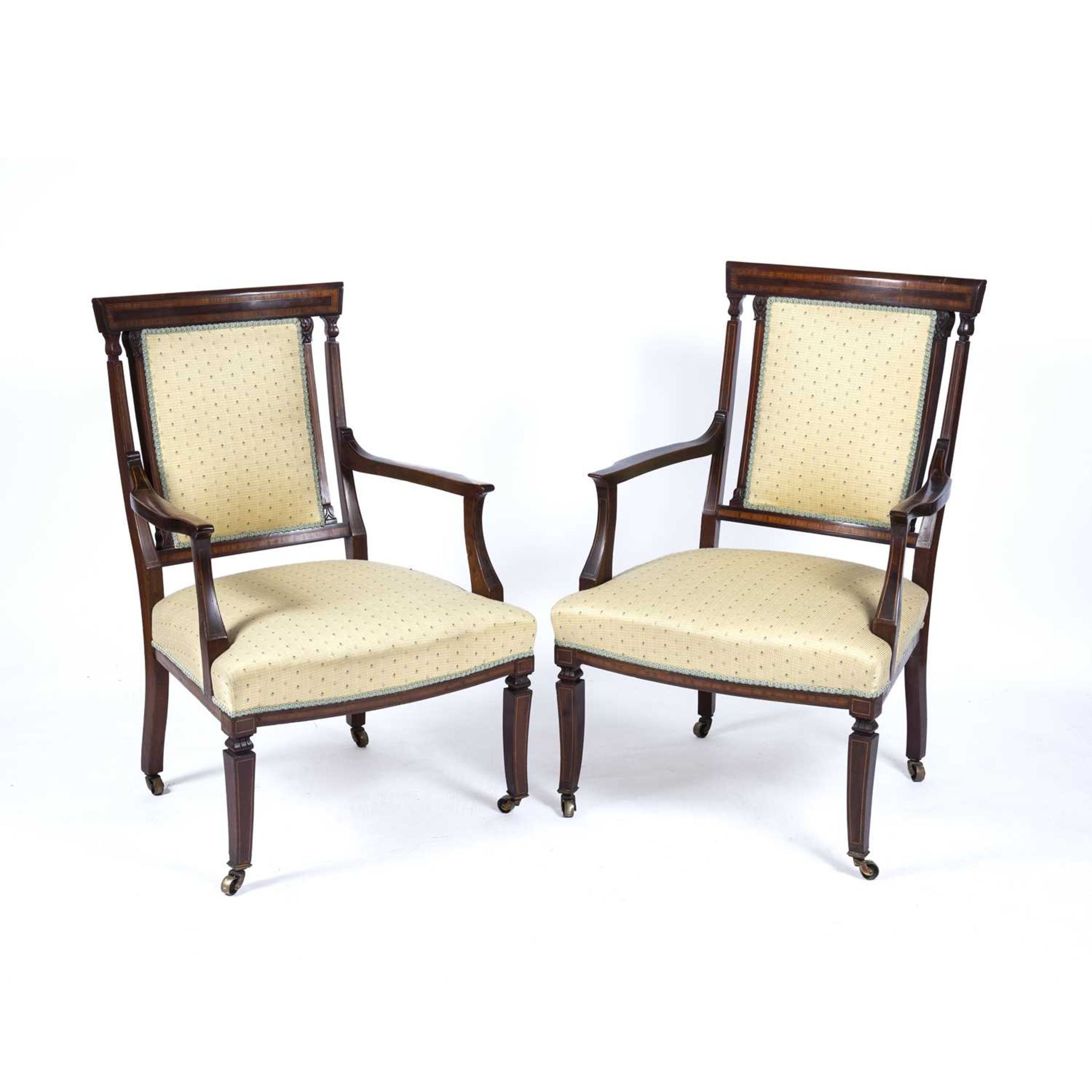 Pair of yellow upholstered armchairs Edwardian, with mahogany and satinwood frames, on brass