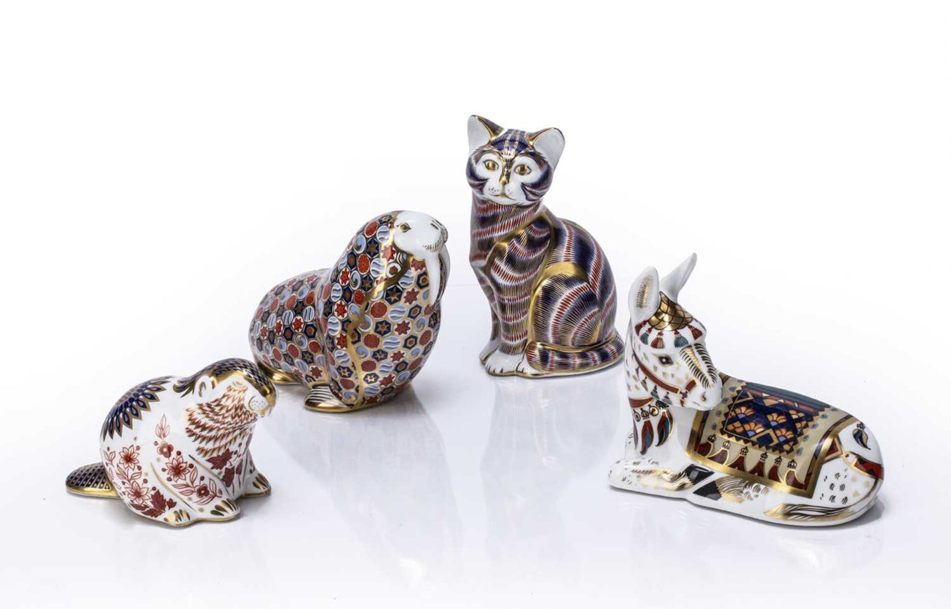 Four Royal Crown Derby paperweights decorated in the Imari colour palette in the form of animals,