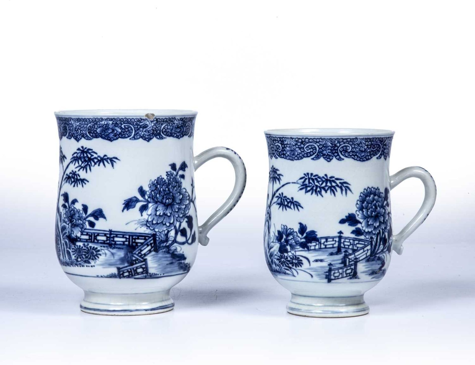 Two English blue transfer mugs late 18th Century, probably Worcester, each decorated with a fence