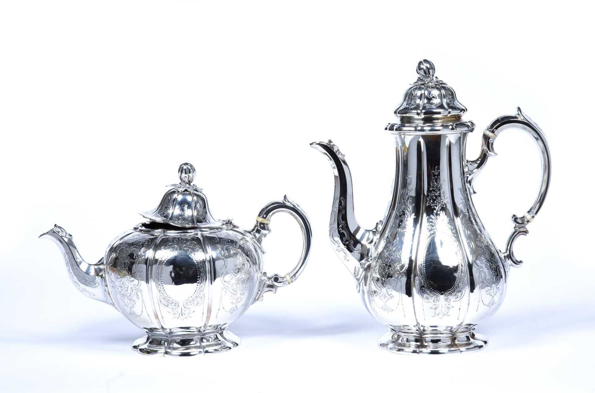 Victorian silver teapot and a Victorian silver coffee pot with matching gourd finials and foliate