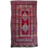 Large red ground rug Moroccan, with panels of geometric design, 160cm x 310cmSome wear