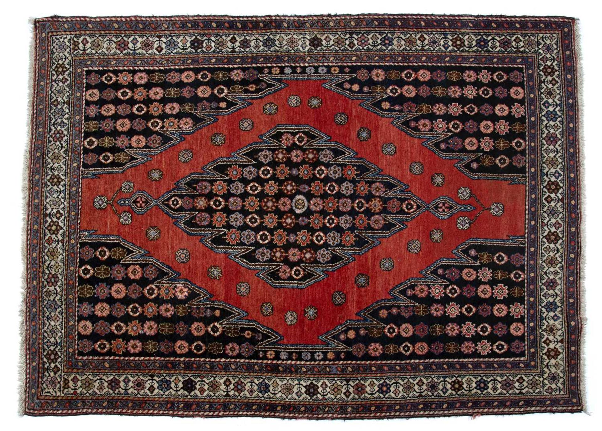 Saveh red ground rug with central stylised panel and with foliate border, 188cm x 139cmSome light