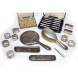 Collection of silver consisting of: silver mounted dressing table brushes, mirror, napkin rings,