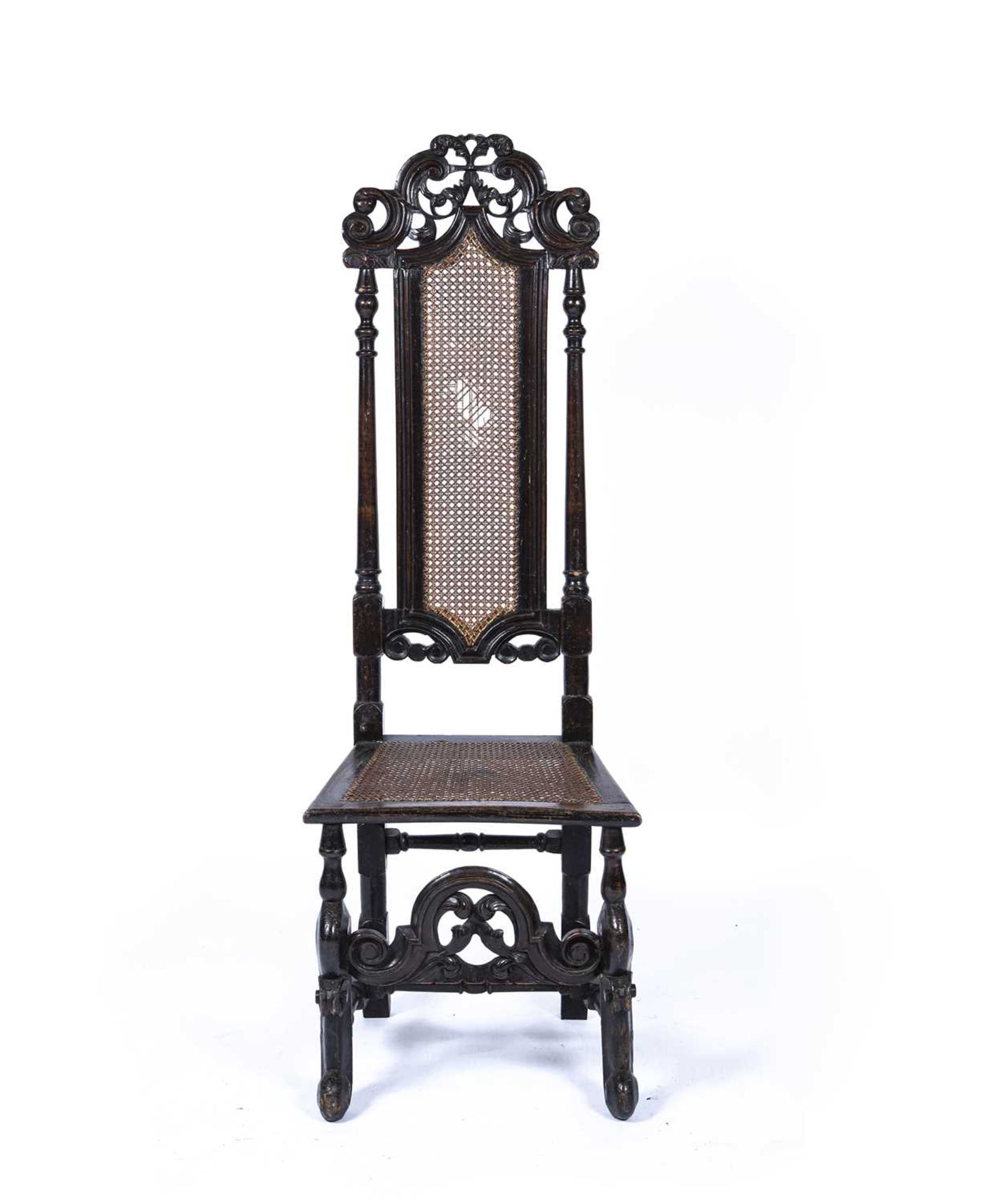 Beech and walnut high back Carolean hall chair 17th Century, with carved back and with cane seat and