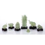 Six carved pieces Chinese, green hardstone on wooden stands, consisting of: wiseman, 11cm high,