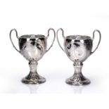 Pair of silver trophy cups with leaf capped trophy handles, on circular bases, bearing marks for R.