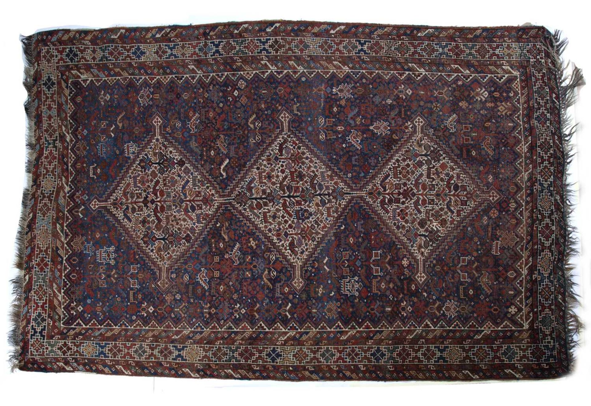 Qashqai carpet with three central medallions depicting birds and foliage, with a repeating geometric