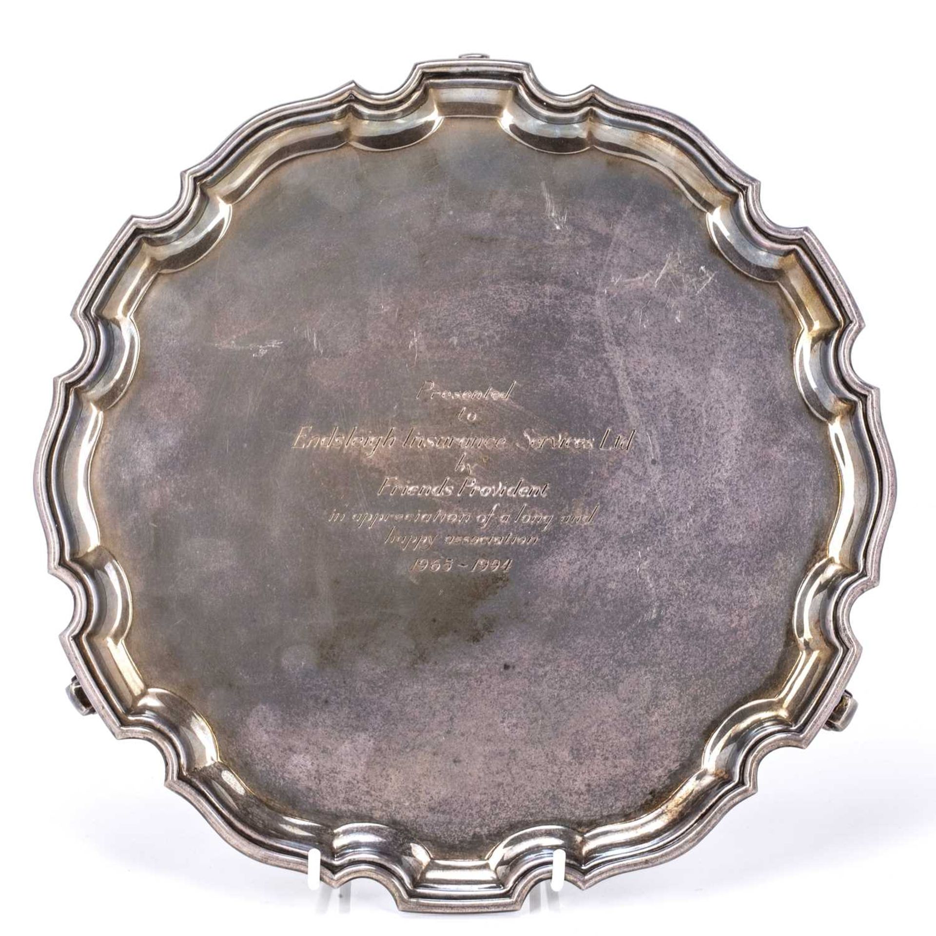 Elizabeth II silver salver standing on three scroll feet, bearing marks for Camelot Silverware