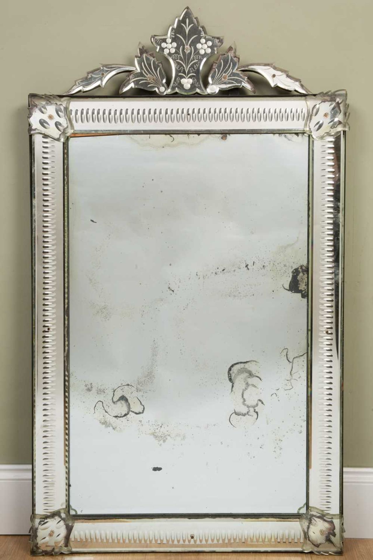 A Venetian-style wall mirror with foliate crest and cut glass mirror slip frame, 72cm wide, 118cm