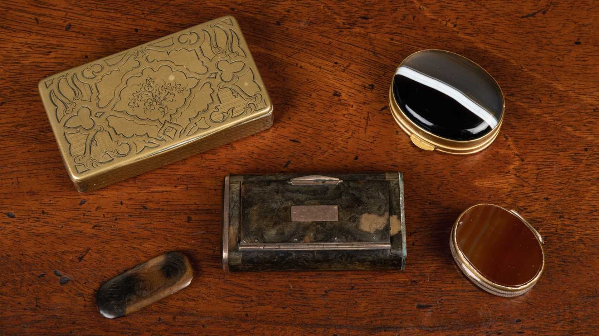 A 19th century French engraved brass snuff box with floral decoration to the lid and tortoiseshell