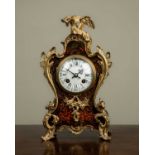 A late 19th century French Boulle decorated mantle clock, the shaped case with ormolu mounts in
