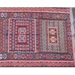 A mid to late 20th century Turkish flat weave Kelim carpet with a red and black ground and geometric