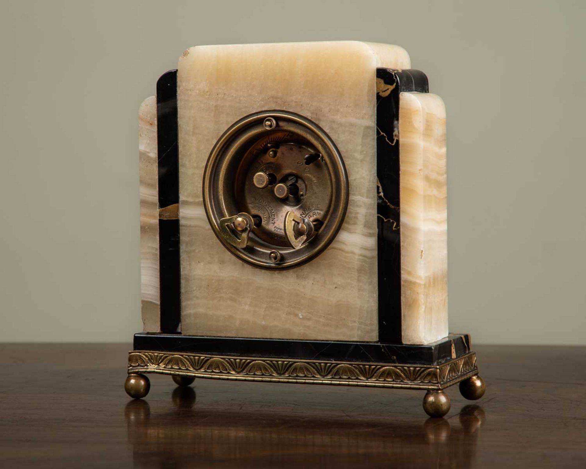 An early 20th century Art Deco timepiece, with stepped onyx and marble case, with an oval dial, with - Image 2 of 3