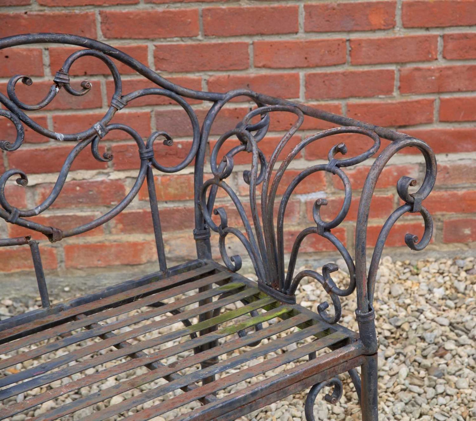 A black painted wrought iron garden seat, with scroll ornament to the back and arms, 141cm wide, - Image 3 of 3