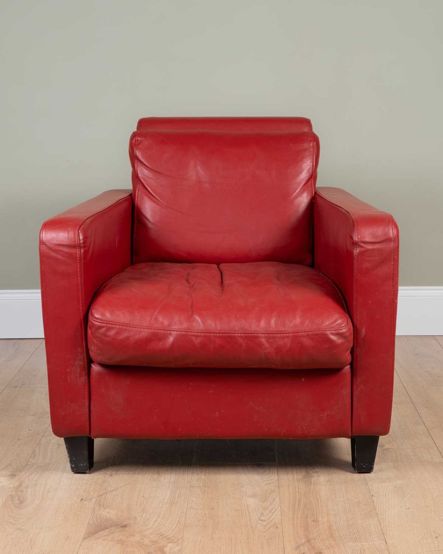 An Art Deco style red leather chair by Habitat, on ebonised square legs, Habitat label to the