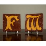 Two William Godwin encaustic terracotta and lettered tiles 'F' and 'M', with stamped mark to the