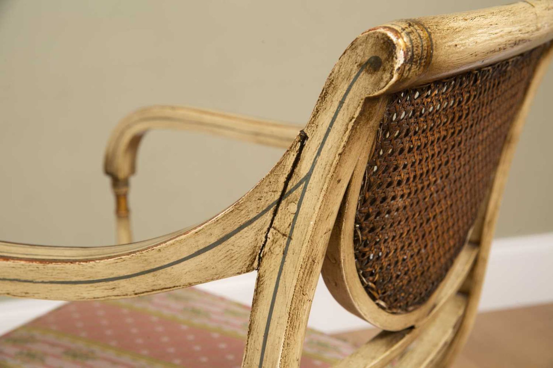 A Regency-style painted elbow chair, with caned back and seat, squab cushion, all standing on turned - Image 4 of 6