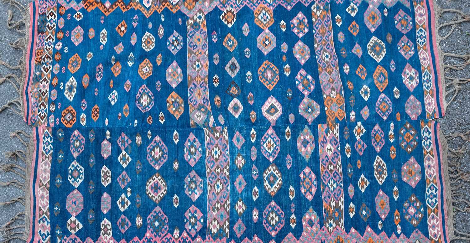 A blue ground Kelim with all over geometric decoration, 124cm x 200cmSome small holes, some