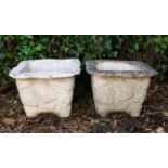A pair of square tapering rusticated cast reconstituted stone planters, 44cm cm square to the top