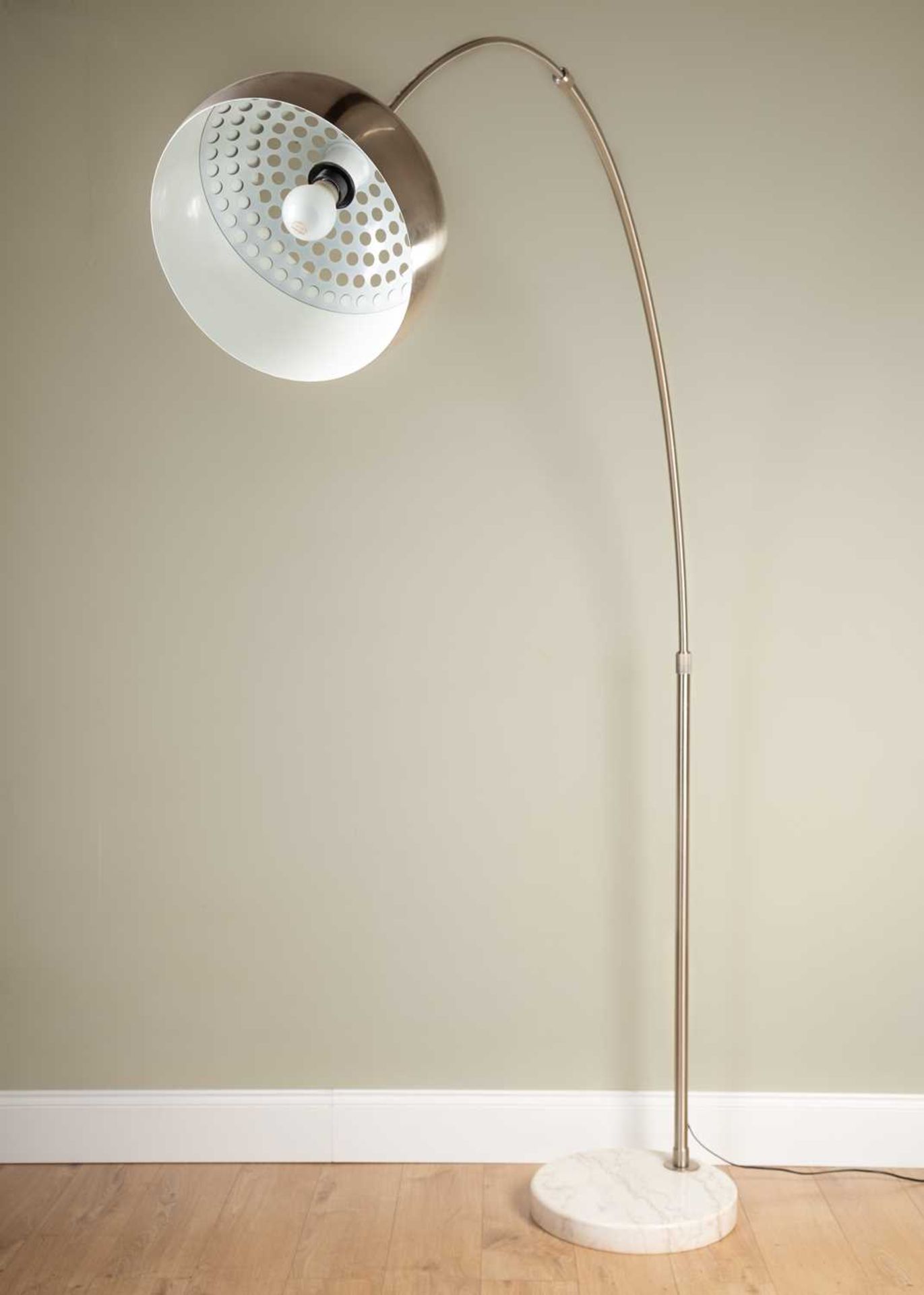 An Arco style floor lamp with arching chrome arm on circular white marble base, approximately