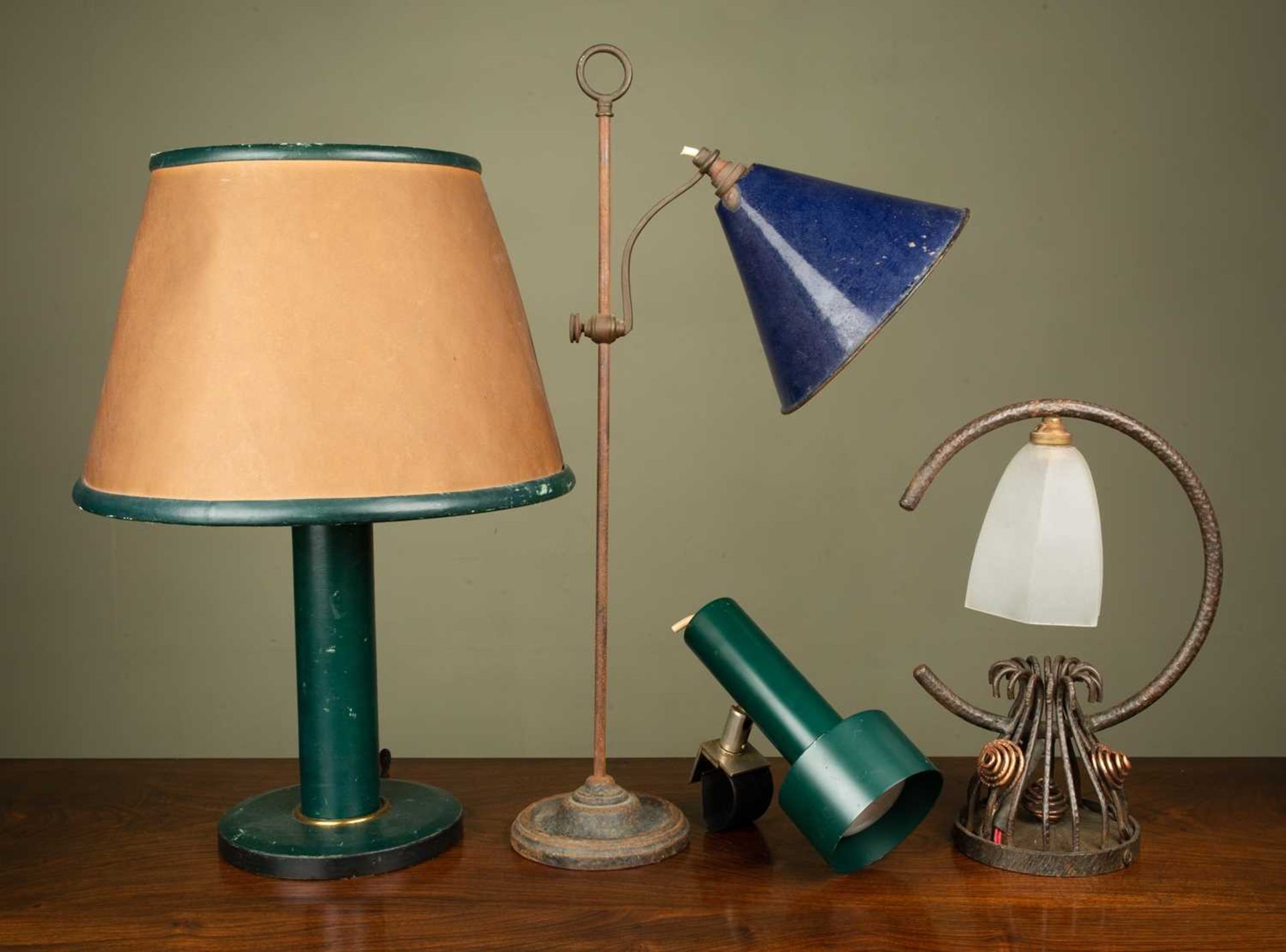 A group of four various table lamps consisting of; a green leather ground table lamp with