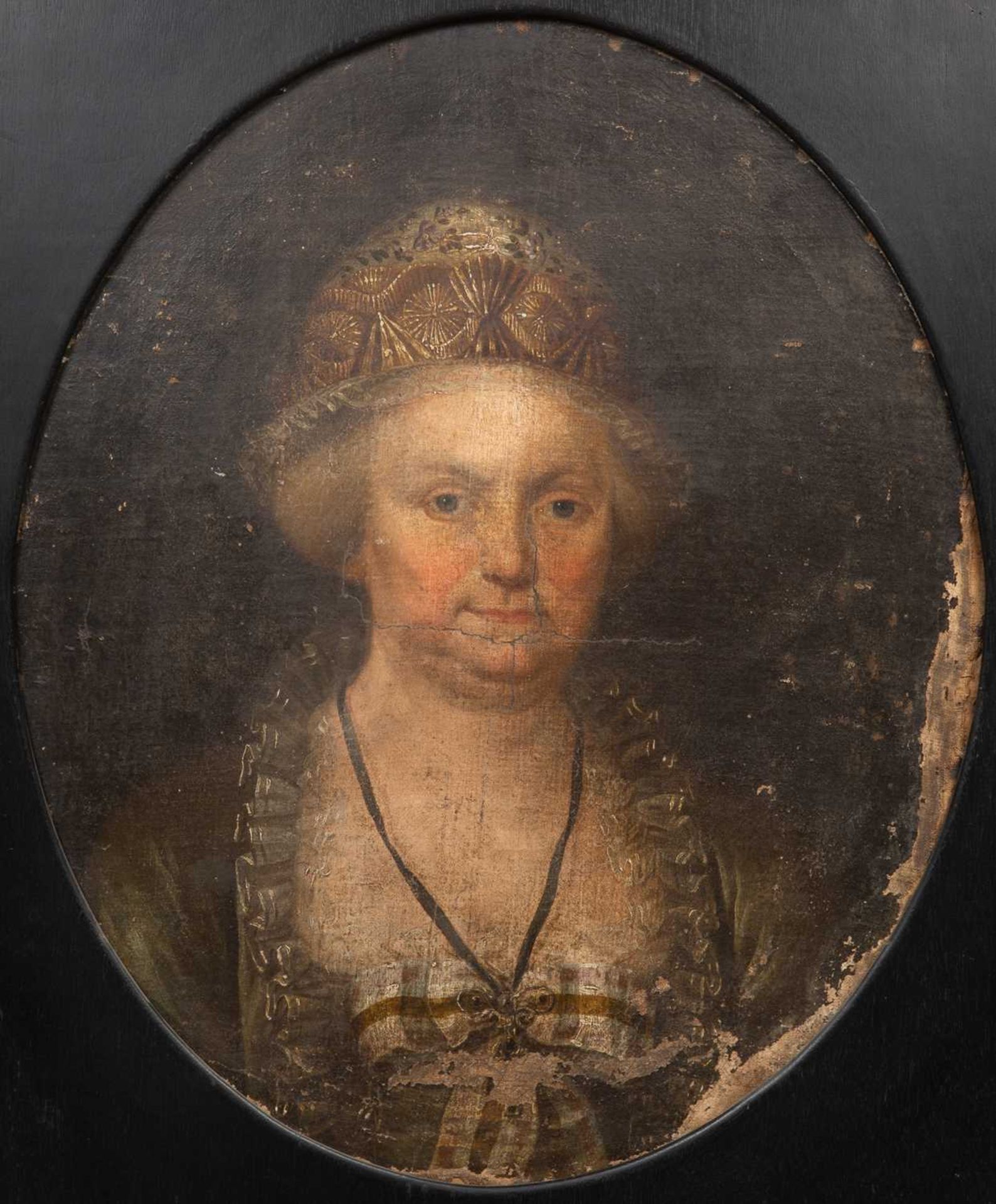 An 18th century portrait of a lady wearing a beaded bonnet, oil on canvas, unsigned, oval, 59.5cm