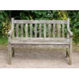 A small teak garden bench with slatted back and seat, 121.5cm wide, 55cm deep, 84cm highWeathered