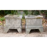 A pair of small cast reconstituted stone square planters on shaped bracket feet, each 36cm wide,