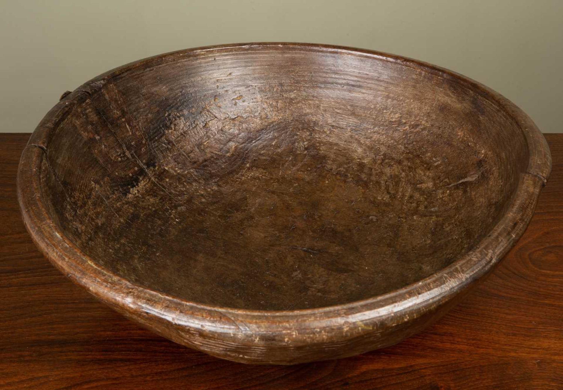 An antique turned sycamore dairy bowl, with old splits and old wrought iron patch, 42cm diameterThis - Image 2 of 4