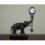 A spelter elephant 'Mystery' clock with modern movement by Unghans, 23cm wide, 9cm deep, 28.5cm