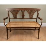 A Thonet Art Deco bentwood cane seat settee, with fountain motif, double back, on slender out