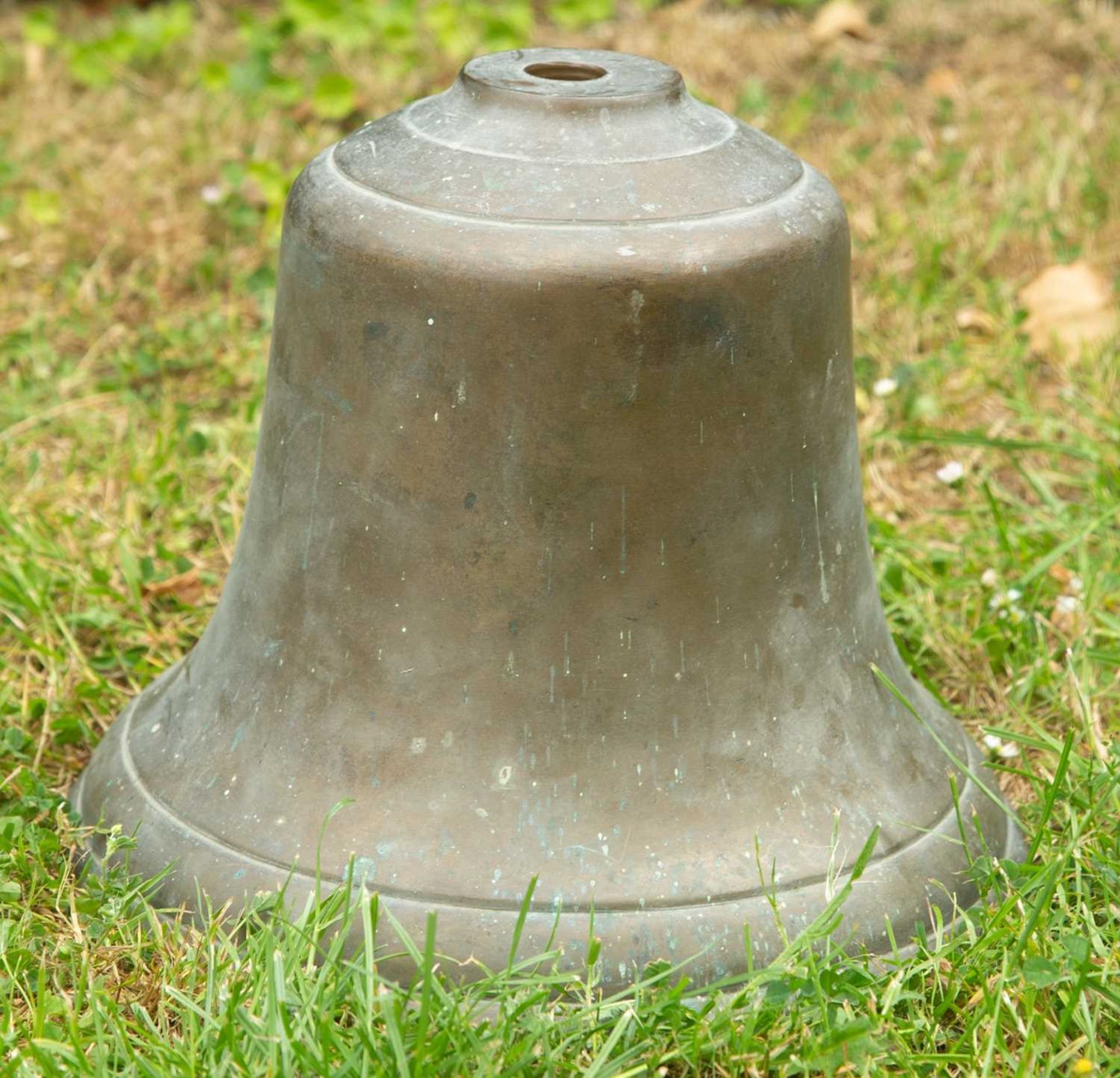 An old military bronze bell, stamped 'ATW', 27cm diameter, 22cm highOxidised but in generally good
