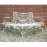 A white painted wrought iron semi-circular tree bench with scrolling arms, approximately 183cm