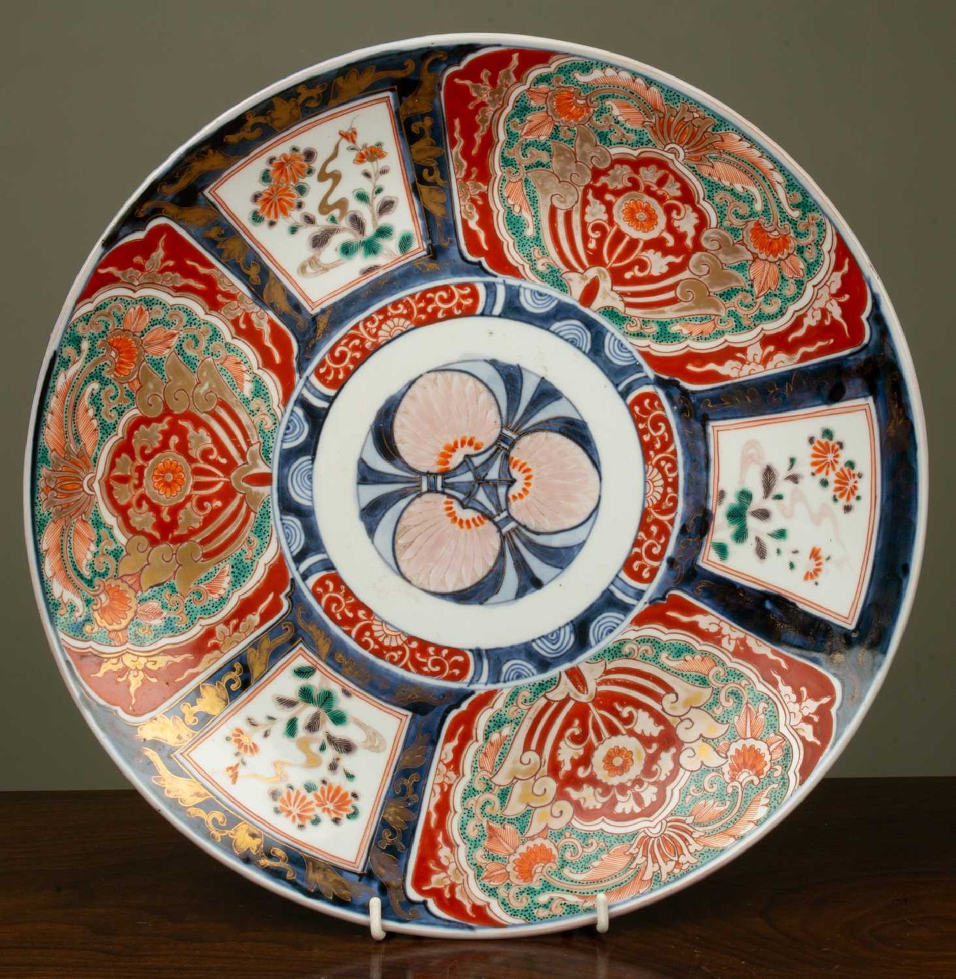 A 19th century Japanese charger, with central stylised flower medallion surrounded by panels of