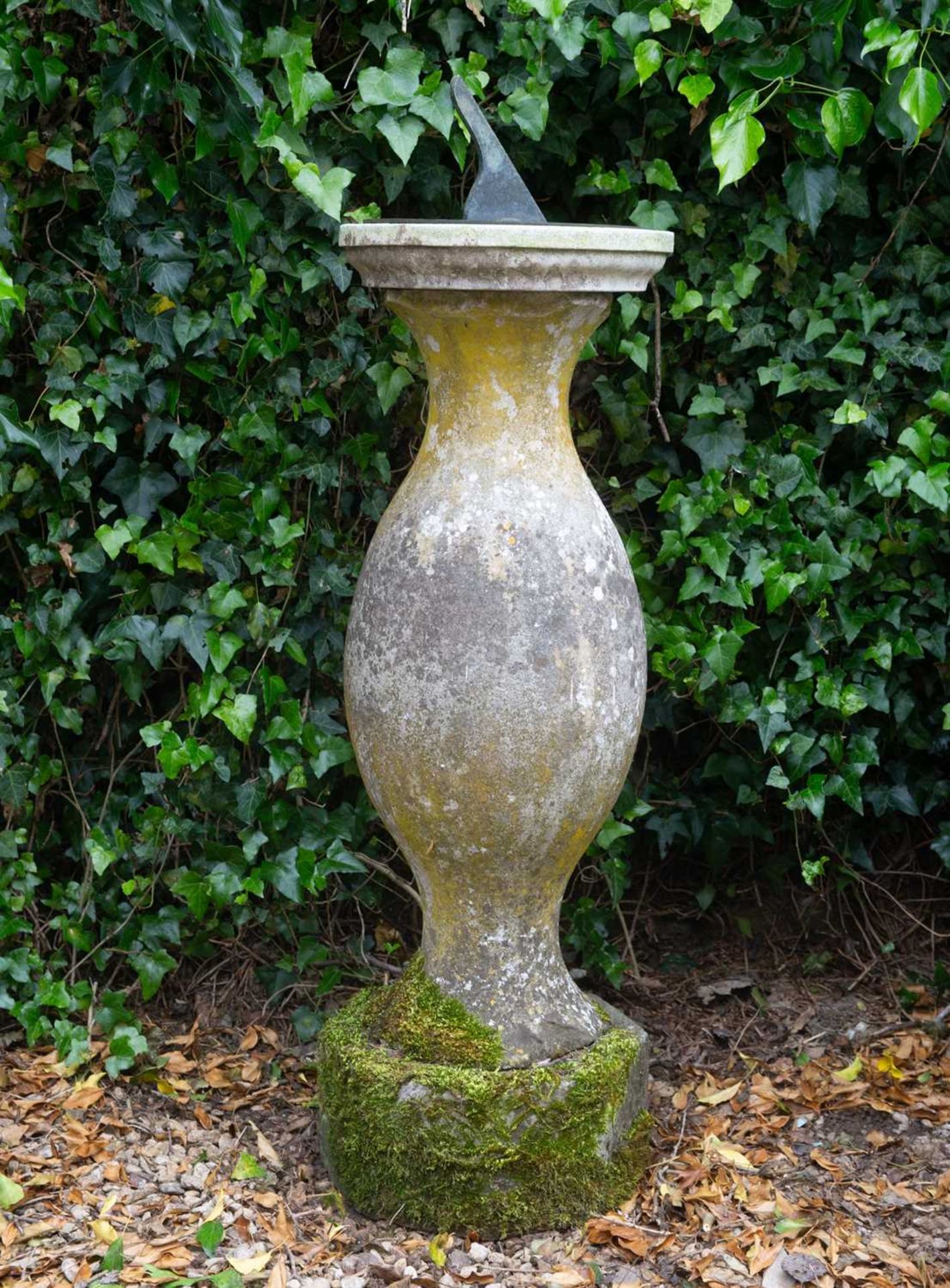 An early 19th Century Sundial by Dolland, the finely engraved bronze dial on a turned stone