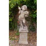 A mid 20th century cast reconstituted stone garden sculpture of a boy holding a basket of flowers,